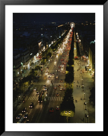 An Elevated View Of A Traffic-Filled Paris Street At Night by Raul Touzon Pricing Limited Edition Print image