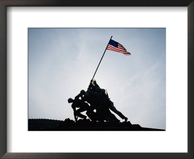 The Iwo Jima Memorial Silhouetted With Flag Flying by Stephen St. John Pricing Limited Edition Print image