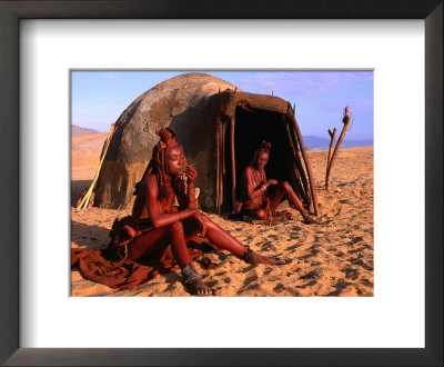 Himba Women In Front Of Traditional Hut, Kaokoveld, Kunene, Namibia by Ariadne Van Zandbergen Pricing Limited Edition Print image