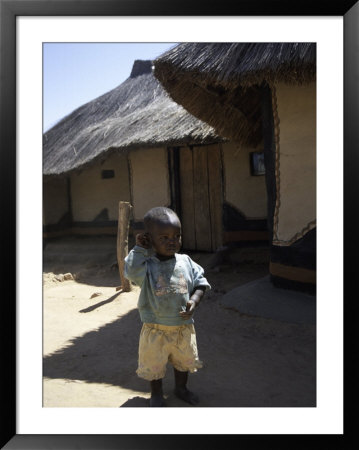 Child By Straw Hut, South Africa by Ryan Ross Pricing Limited Edition Print image