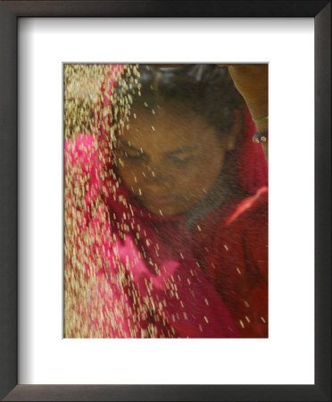 Girl In Red Sari Winnowing Wheat, Rajasthan, India by Keren Su Pricing Limited Edition Print image