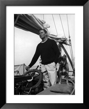 Errol Flynn With His Dog At The Helm Of A Yacht While Enjoying A Fishing Vacation by Peter Stackpole Pricing Limited Edition Print image