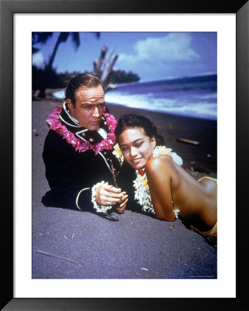 Marlon Brando With Mutiny On The Bounty's Tahitian Tarita Lying Together On The Beach by Grey Villet Pricing Limited Edition Print image