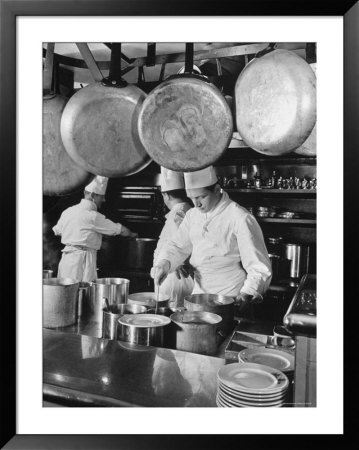 Chefs Cooking In A Restaurant Kitchen At Radio City by Bernard Hoffman Pricing Limited Edition Print image