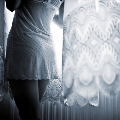 A Young Woman Standing In Underwear Near A Window by Jewgeni Roppel Pricing Limited Edition Print image