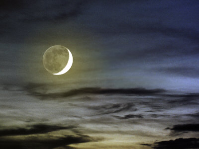Crescent Moon Shot Through Thin Clouds, Lake Constance, Germany by Images Monsoon Pricing Limited Edition Print image