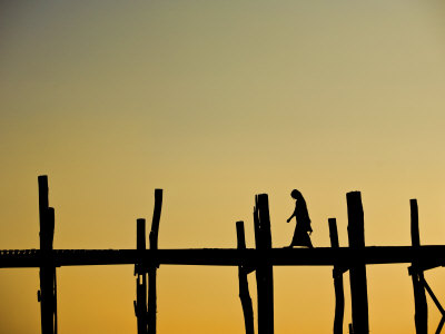 Lone Woman Walking On The U Bein Bridge At Sunset In Mandalay, Burma by Scott Stulberg Pricing Limited Edition Print image