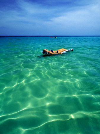 Young Woman Lying On A Pool Raft In The Sea, Koh Samui, Thailand by Scott Stulberg Pricing Limited Edition Print image