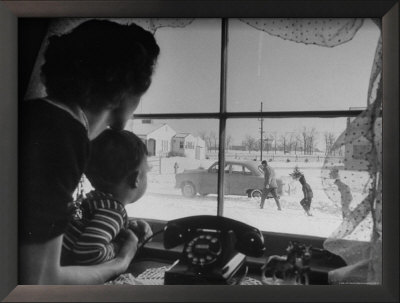 Mother And Child Looking Out Window As Father And Older Brothers Walk To Car In Snow by Alfred Eisenstaedt Pricing Limited Edition Print image