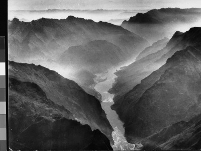 Aerial View Of Yangtze River Gorge Shrouded In Mist With River Winding Through Steep Rocky Hills by Dmitri Kessel Pricing Limited Edition Print image
