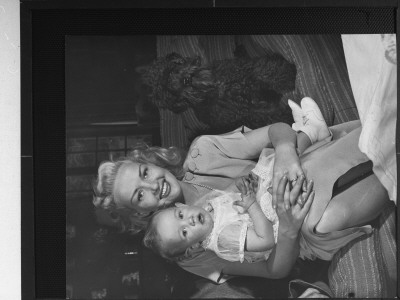 Betty Grable Holding Daughter Vicky On Her Lap Next To Their Terrier Dog In Birthday Celebration by Peter Stackpole Pricing Limited Edition Print image