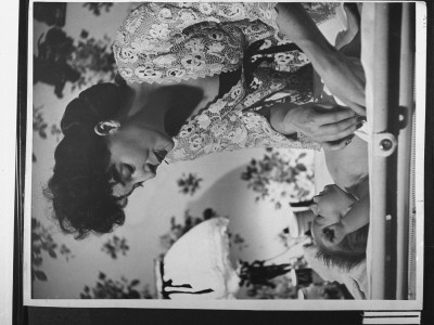 Gypsy Rose Lee With Safety Pin In Her Mouth As She Tenderly Diapers Her 9-Mo-Old Son Erik by Eliot Elisofon Pricing Limited Edition Print image