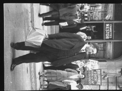 French Statesman Edouard Herriot Waiting In Street For Taxi With Briefcase In Hand by Alfred Eisenstaedt Pricing Limited Edition Print image