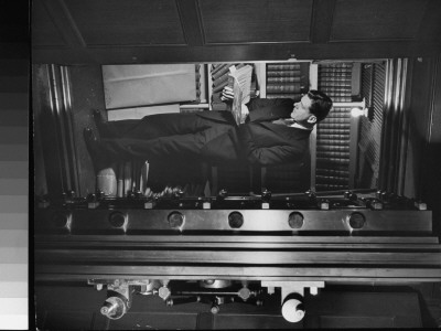 Man Looking At Book Behind Open Door At Vault In The New York Public Library by Alfred Eisenstaedt Pricing Limited Edition Print image