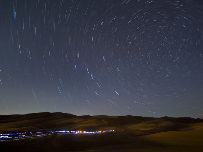 Hikers And Stars On The Great Sand Dunes, Colorado by Geoffrey George Pricing Limited Edition Print image