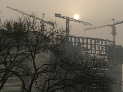 The Sun Sets Behind The New Polly Plaza, Under Construction At Dongsishitiao In Central Beijing by Ben Mcmillan Pricing Limited Edition Print image