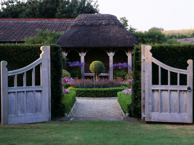 Double Gates Open - Across Formal Topiary Garden To Thatched Summer House At Lady Farm, Somerset by Clive Nichols Pricing Limited Edition Print image