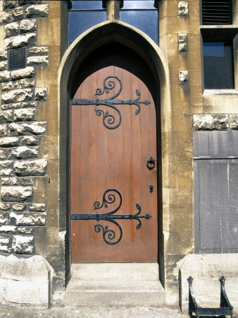 Doors - Ecclesiastical Style Door With Ornate Ironmongery, Hinged In Rough Cast Stone Building by David Mark Soulsby Pricing Limited Edition Print image