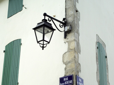 Streetlamp And Shuttered Windows, Il De Re, France by Olwen Croft Pricing Limited Edition Print image