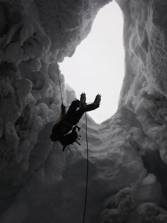 Climber In Snowy Crevasse, Switzerland by Michael Brown Pricing Limited Edition Print image