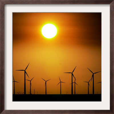 A Group Of Wind Turbines Are Silhouetted By The Setting Sun by Charlie Riedel Pricing Limited Edition Print image