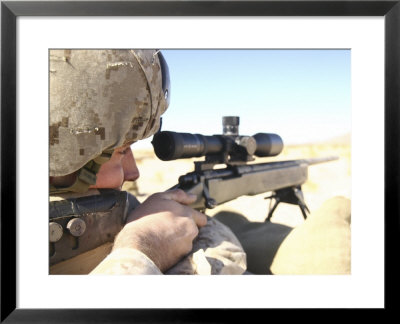A Soldier Aims In With His M40a3 Scout Sniper Rifle While Taking Shots At Green Ivan Targets by Stocktrek Images Pricing Limited Edition Print image