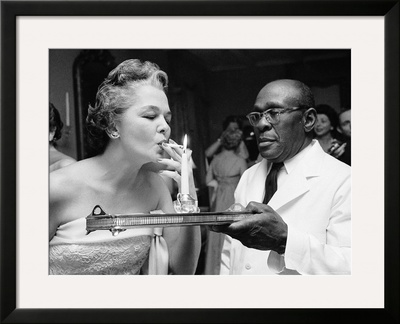 Woman Lighting A Cigarette From A Candle Held By A Waiter At The Piedmont Ball by Paul Schutzer Pricing Limited Edition Print image