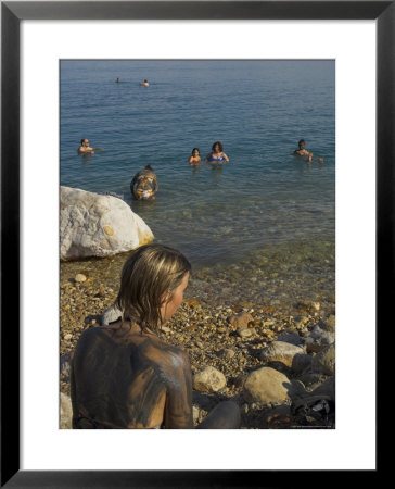 Woman's Back Covered With Mud And People Floating In The Sea In Background, Dead Sea, Israel by Eitan Simanor Pricing Limited Edition Print image