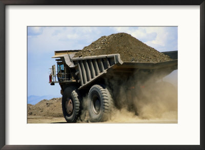 A Dump Truck Carrying Gravel Kicks Up A Cloud Of Dust by Raymond Gehman Pricing Limited Edition Print image
