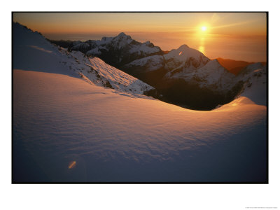 Sunset Glow Over A Snowy Mountain Face by Annie Griffiths Belt Pricing Limited Edition Print image