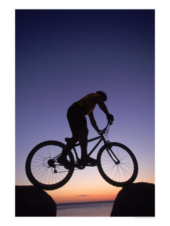 Silhouette Of Mountain Biker On Rock, Baja, Mexico by Eric Sanford Pricing Limited Edition Print image
