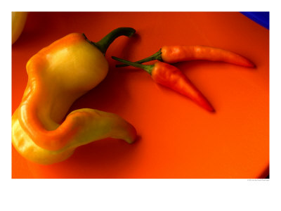 Chilli Peppers In Varying Shades On An Orange Plate, Australia by John Hay Pricing Limited Edition Print image