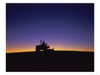 Silhouette Of Worker Cutting Grass At Sunrise by Kent Dufault Pricing Limited Edition Print image