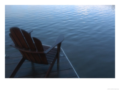 An Adirondack Chair Silhouetted By A Lake by Stacy Gold Pricing Limited Edition Print image