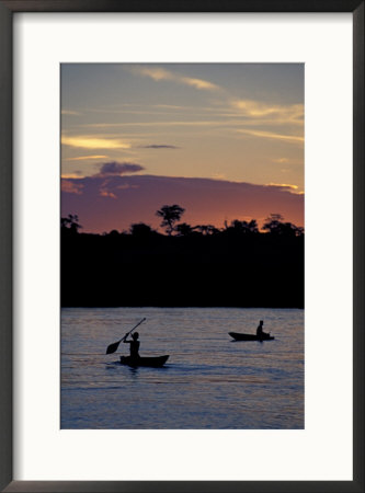 Boaters On Amazon River At Sunset, Amazon River Basin, Peru by Nik Wheeler Pricing Limited Edition Print image