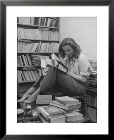 French Actress Barbara Laage, Alone In Her Apartment Reading by Nina Leen Pricing Limited Edition Print image