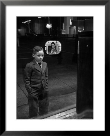 Boy Watching Tv On Store Window Set, Glass Reflects The Image Off Tv Screen by Ralph Morse Pricing Limited Edition Print image