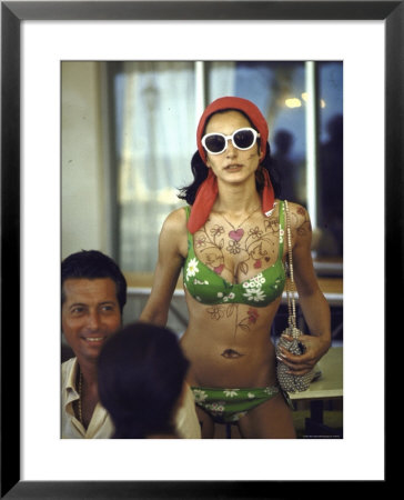 Model Naty Abascal Wearing Bikini, Showing Off Designs On Chest And Stomach At Paradise Islands by Bill Eppridge Pricing Limited Edition Print image