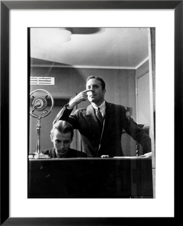 Wolfe, Nbc Radio Director, Makes Timing Gestures Through The Glass Window Of The Control Room by Alfred Eisenstaedt Pricing Limited Edition Print image