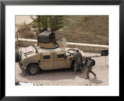Us Military Soldiers Take A Well Earned Break In The Forground Of The Baghdad Hotel by Stocktrek Images Pricing Limited Edition Print image