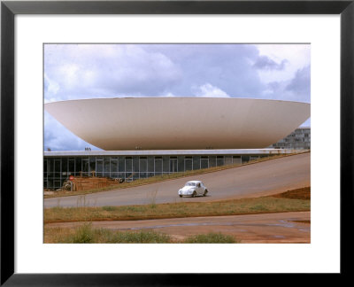 Three Powers Square Building Built By Oscar Niemeyer As Volkwagan Drives By by Dmitri Kessel Pricing Limited Edition Print image