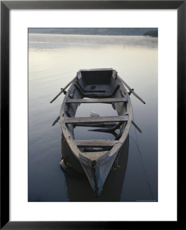 Timeworn Boat Rests On A Calm Lake by Raul Touzon Pricing Limited Edition Print image