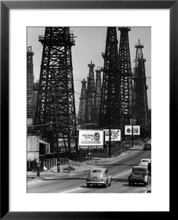 Car Traffic On Highway Next To Advertising Billboards And Oil Well Towers, Signal Hill Oil Field by Andreas Feininger Pricing Limited Edition Print image