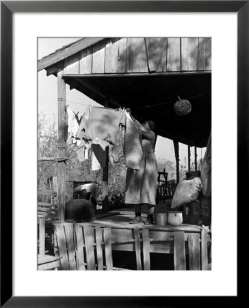Old African American, Sharecropper Wife, Lizzie Alexander Hanging Laundry Out To Dry On Her Porch by Alfred Eisenstaedt Pricing Limited Edition Print image