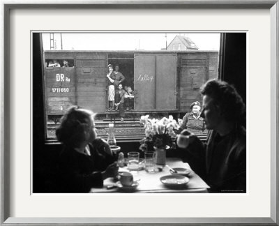 Wife And Daughter Of Us Soldier In First Class Dining Car Looking At German Expelles In Boxcars by Walter Sanders Pricing Limited Edition Print image