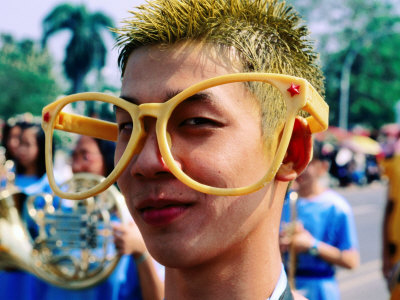 Portrait Of Boy With Colourful Hair And Spectacles In Spring Festival Parade, Chiang Mai, Thailand by Alain Evrard Pricing Limited Edition Print image