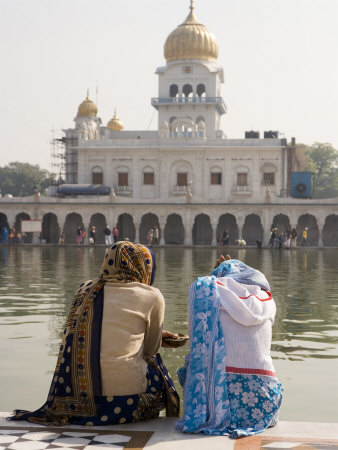 Two Women Sitting Beside Holy Water Pool At Sikh Gurdwara Bangla Sahib Temple In New Delhi by Gavin Gough Pricing Limited Edition Print image