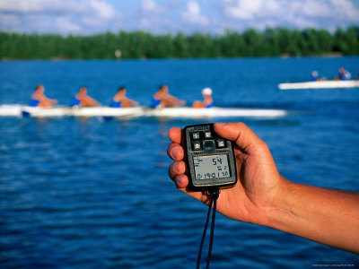 Hand Holding Stopwatch With Crew Team In Background by Mark Segal Pricing Limited Edition Print image