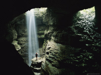 Caver Stands Underground In Front Of A Waterfall by Stephen Alvarez Pricing Limited Edition Print image