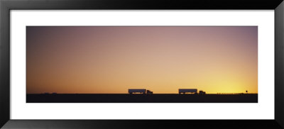Silhouette Of Two Trucks Moving On A Highway, Interstate 5, California, Usa by Panoramic Images Pricing Limited Edition Print image